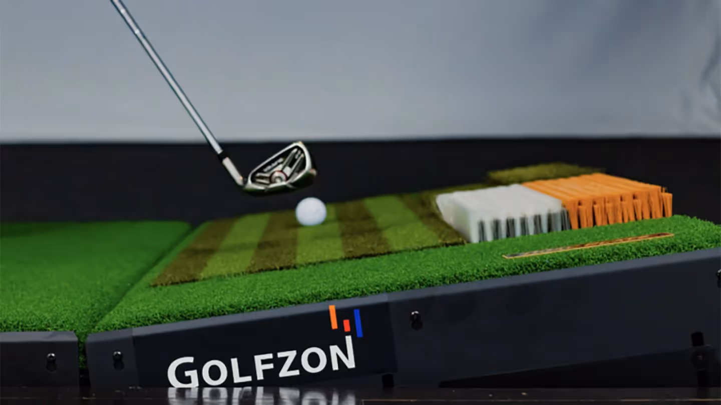 Golf instructor working with student